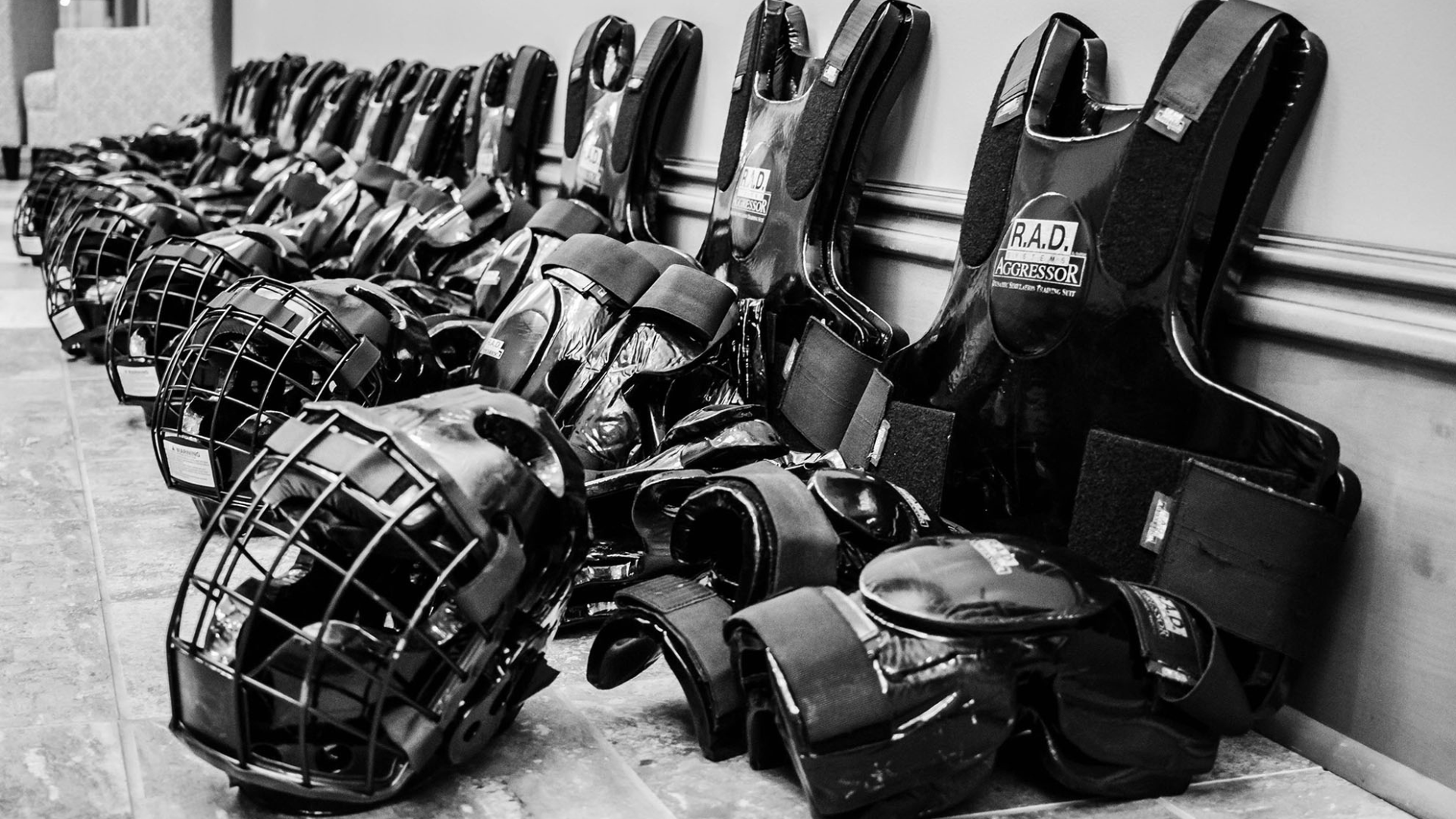 black & white photo of self-defense practice pads & helmets